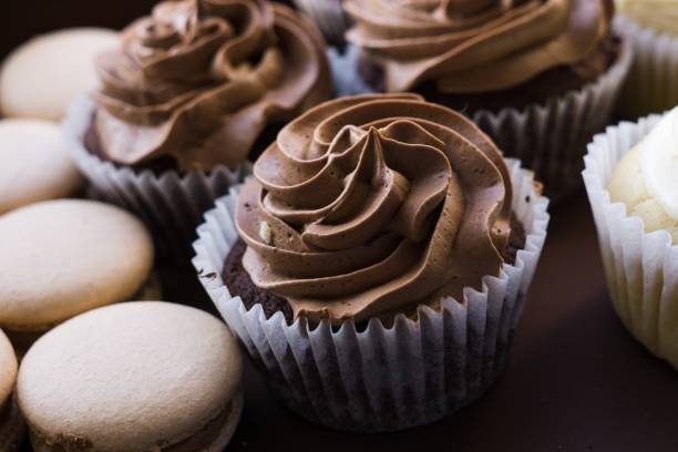 istock Cupcakes and macron cakes on the plate. 1398814289