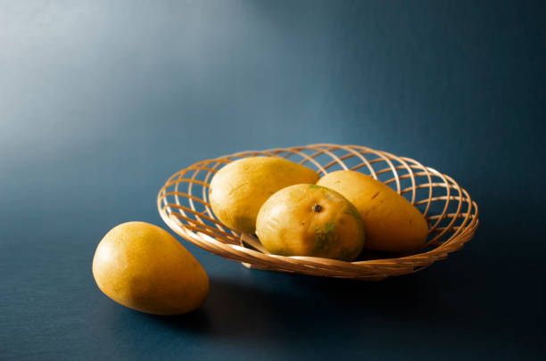 istock mangoes in basket blue dark background 1398814424