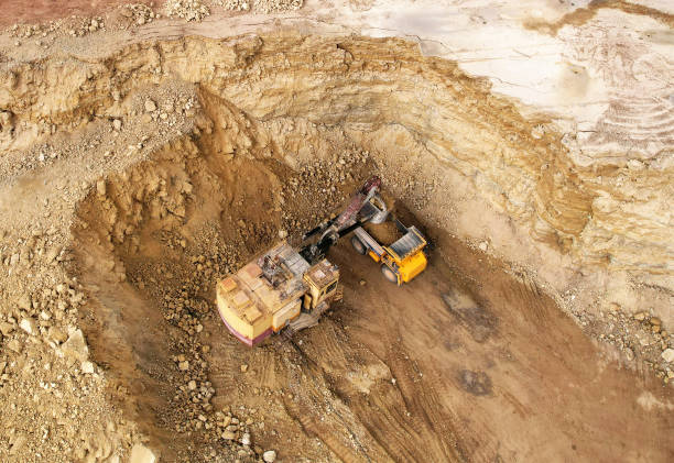 istock Excavator in open pit on dolomite development. Mining clay in quarry. Opencast for the extraction limestone. 1398815472