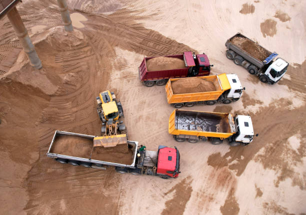 istock Wheel loader load sand in dump truck in open pit. 1398815810