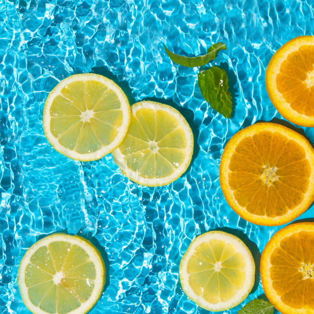 istock Tropical fruit pattern of orange and lemon slices with mint leaves. Summer composition of fruits and vitamins. Summer vibes. 1398816025