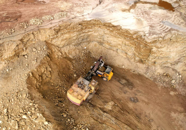 istock Excavator in open pit on dolomite development. Mining clay in quarry. Opencast for the extraction limestone. 1398817810