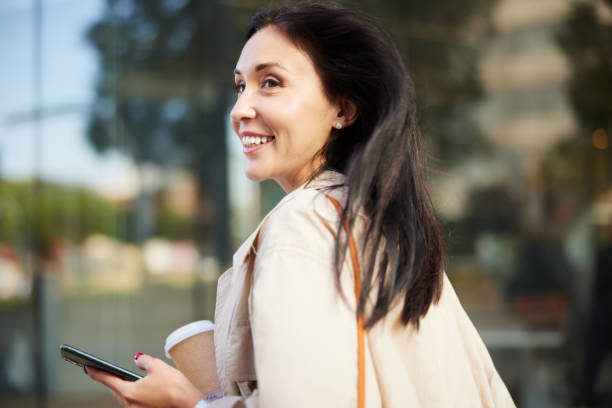 istock A beautiful woman at rush hour walks back home from work. 1398820312