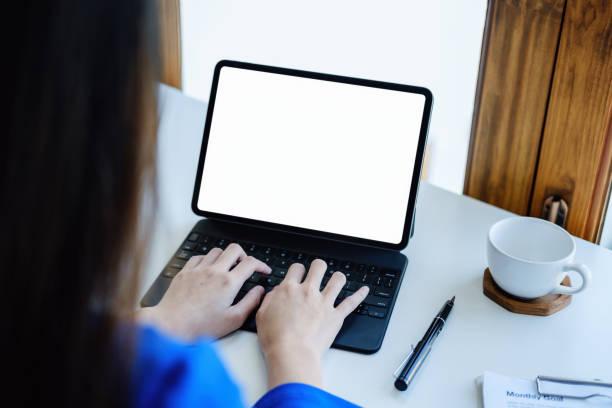 istock A business woman using blank white screen tablet computer with a calculator to calculate budget documents on his desk 1398820978