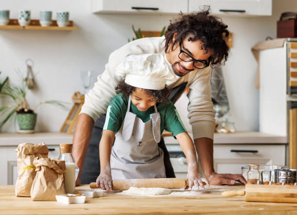 istock Positive black father and son cooking together 1398821929