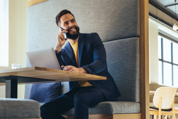 istock Happy young businessman speaking on a phone call 1398822134