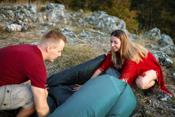 istock Young couple setting up a tent in nature 1398823926