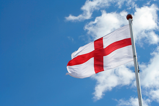 Flag of St George against a blue sky (with room for text).