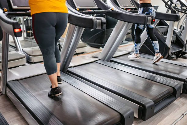 istock Two Young Women Running On A Treadmill 1398824677