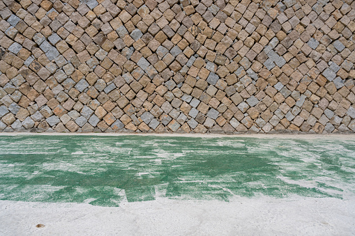 A stone wall and an empty road