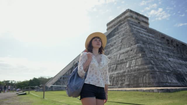 Woman on the background of Chichen Itza pyramid in Mexico