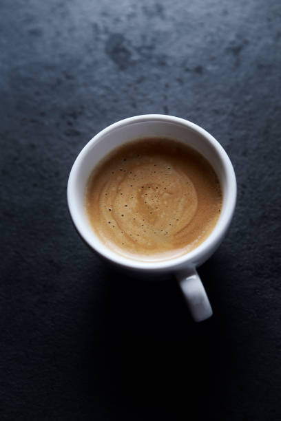 istock Cup of coffee on dark stone background. Close up. Copy space. 1398828406