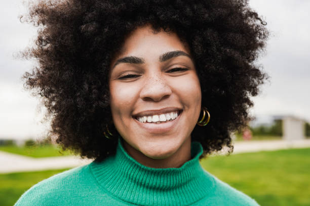 istock Young african woman smiling on camera 1398829428