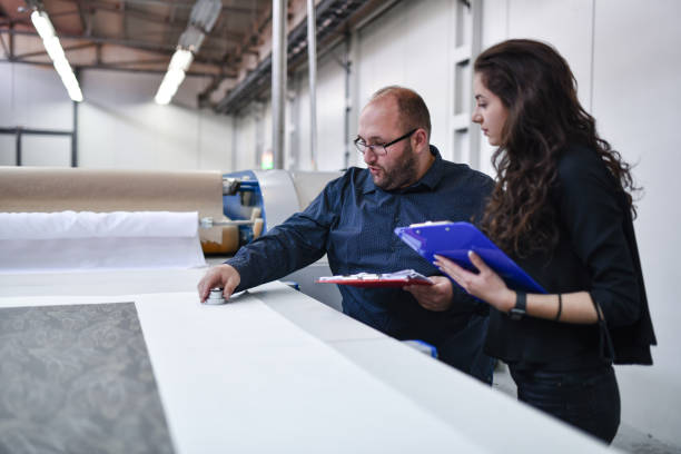istock Two Senior Inspectors In Textile Factory Analyzing Material Quality 1398829630