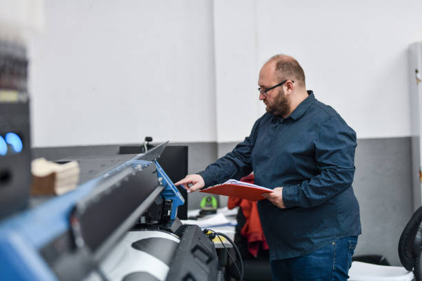 istock Bearded Male Textile Factory Worker Programming Printing Machine 1398829869