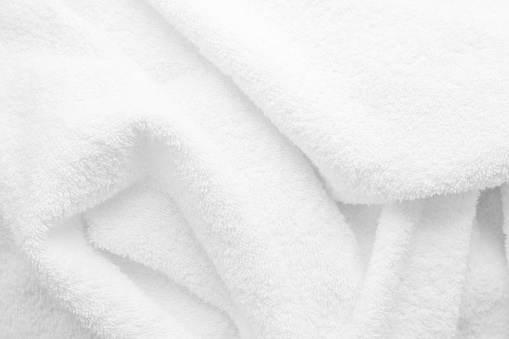 texture of white terry cloth close up. Material for towel, blanket