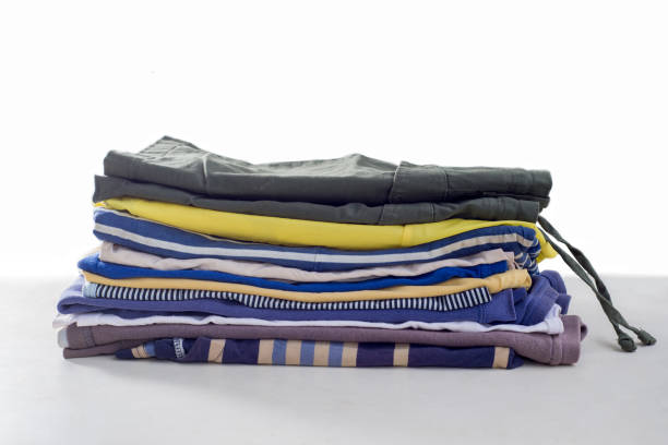 istock Stack of used clothes. Organizing the wardrobe. Sustainable living concept, sorting second hand for recycling 1398833254