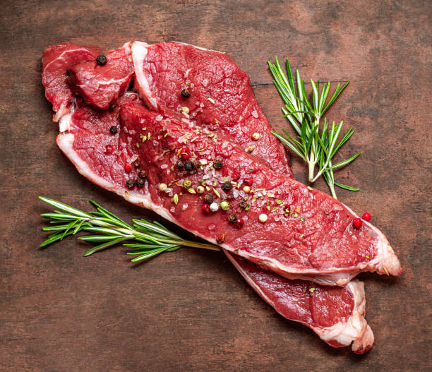 istock Fresh raw beef steak meat on old wooden table. 