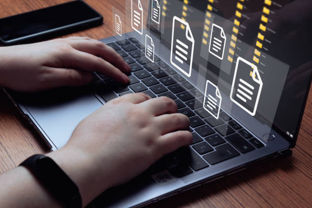 istock Woman use laptop with virtual holographic interface of documents. 1398834693