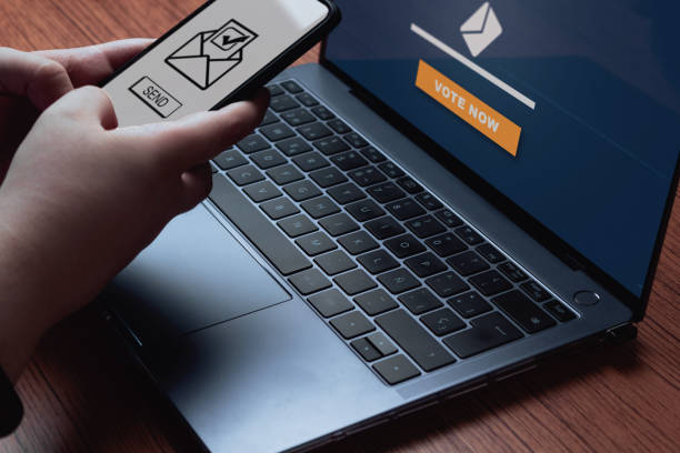 istock Woman use laptop and smartphone for voting online. 1398835005