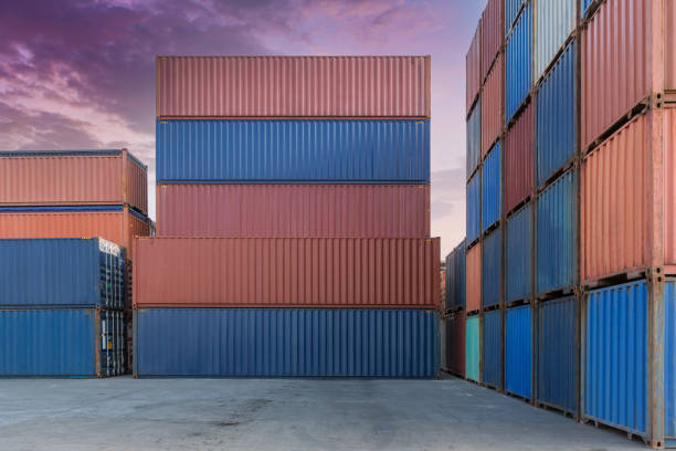 istock Stack of containers in a harbor. Shipping containers stacked on cargo ship. Background of Stack of Containers at a Port. 1398835038