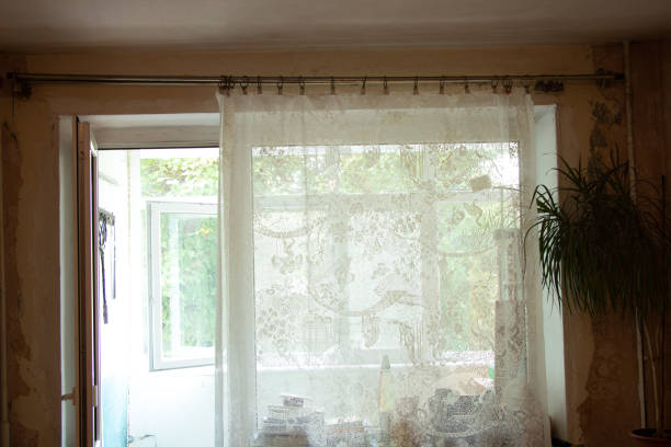 istock an old room with a window in a Soviet apartment in Ukraine without renovation with empty walls and torn wallpaper, a room before renovation 1398835114