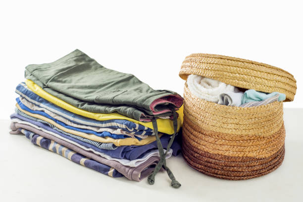 istock Stack of used clothes and a laundry basket. 1398835227
