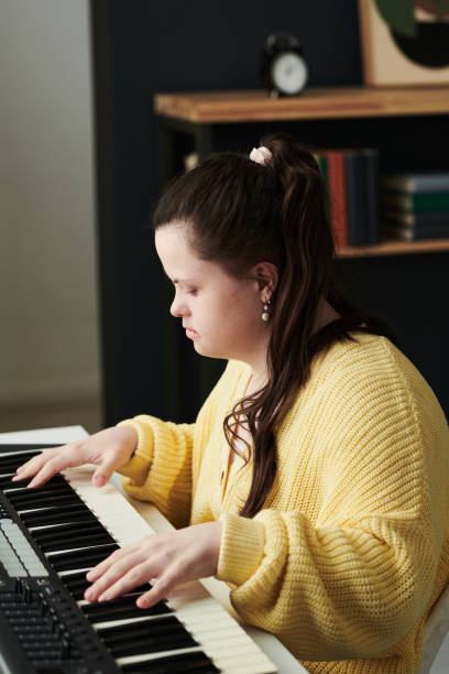 istock Woman With Disability Playing Synthesizer 1398836466