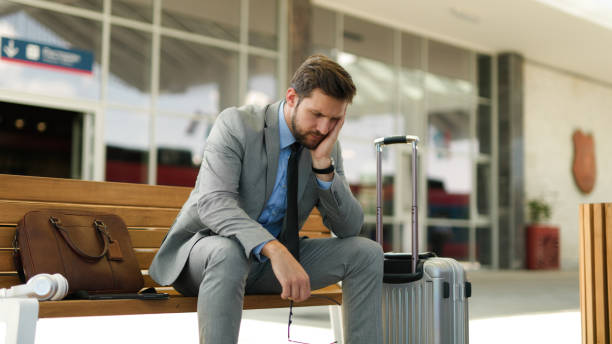 istock Pensive businessman is waiting at train station alone 1398837966