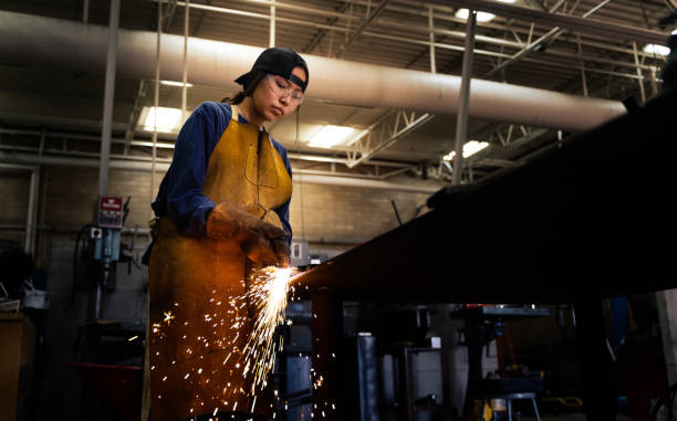 istock Female teenager practicing torch cutter skills at a workshop 1398839537