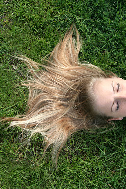 istock Blond woman lying on grass 139884001