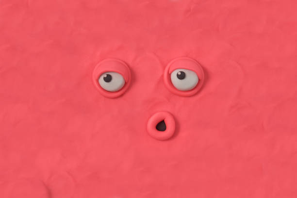istock Ugly monster with an indifferent expression, fabulous creature made by hand from pink plasticine. Scary face of alien monster. 3d artwork 1398842501