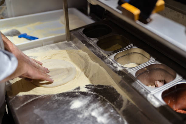 istock Male chef hands making pizza in the pizzeria kitchen 1398844294