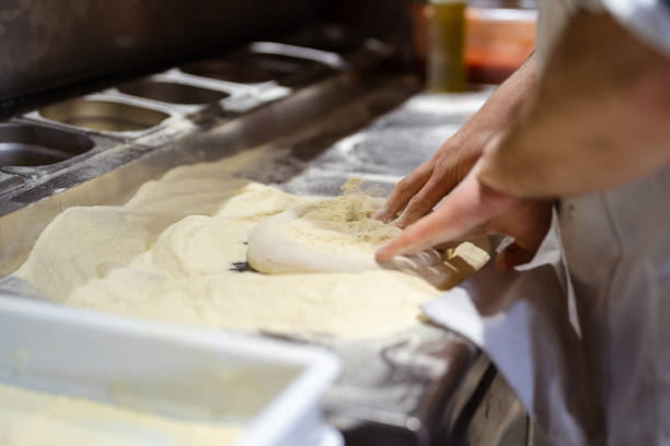 istock Male chef hands making pizza in the pizzeria kitchen 1398844336