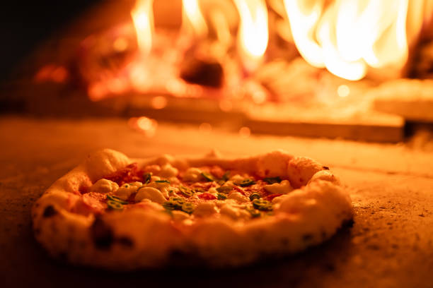 istock Pizza oven burning in flames getting ready to bake pizza 1398844339