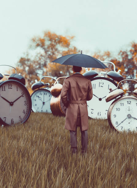 istock Big old fashioned alarm clocks stands on a field 1398845171