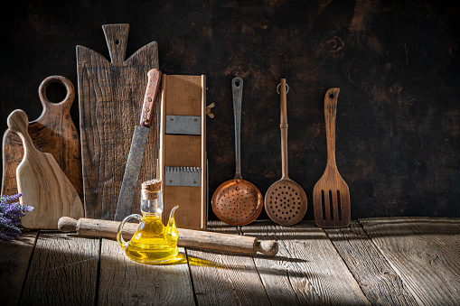 Rustic kitchen background with copy space on wood table with kitchenware and cutting boards