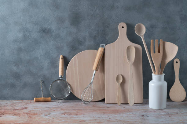 istock Modern kitchen kitchenware in light wood color with ladle, cutting boards and cookware on gray 1398845286