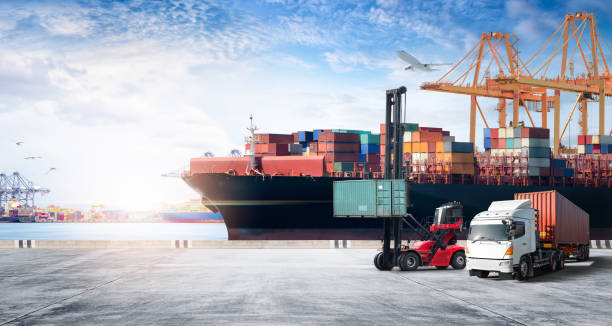 istock Container cargo freight ship during discharging at industrial port move to container yard by trucks, handlers, cargo plane, copy space, logistic import export background and transport industry concept 1398847327