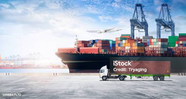 Container Cargo Freight Ship During Discharging At Industrial Port Move To Container Yard By Trucks Handlers Cargo Plane Copy Space Logistic Import Export Background And Transport Industry Concept Stock Photo - Download Image Now