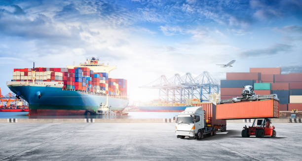 istock Container cargo freight ship during discharging at industrial port move to container yard by trucks, handlers, cargo plane, copy space, logistic import export background and transport industry concept 1398847663