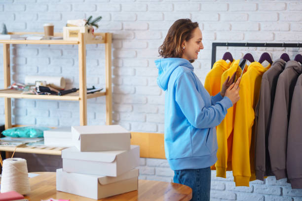 istock Small business owner, entrepreneur, seller using tablet checking ecommerce clothing store orders. 1398850430