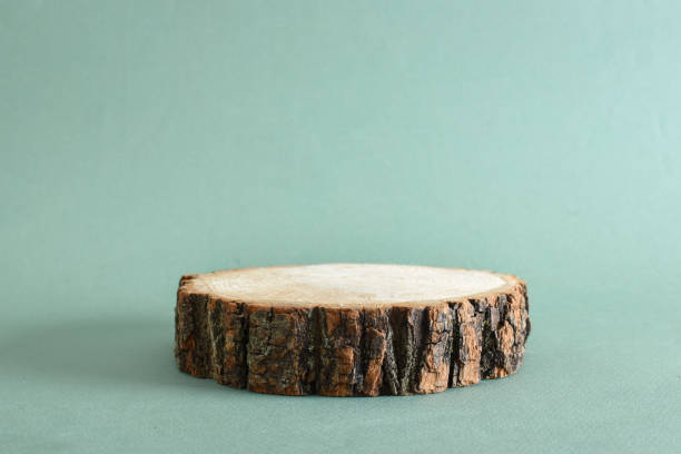 istock Podium with a larch branch and a cone on a green background. 1398852366