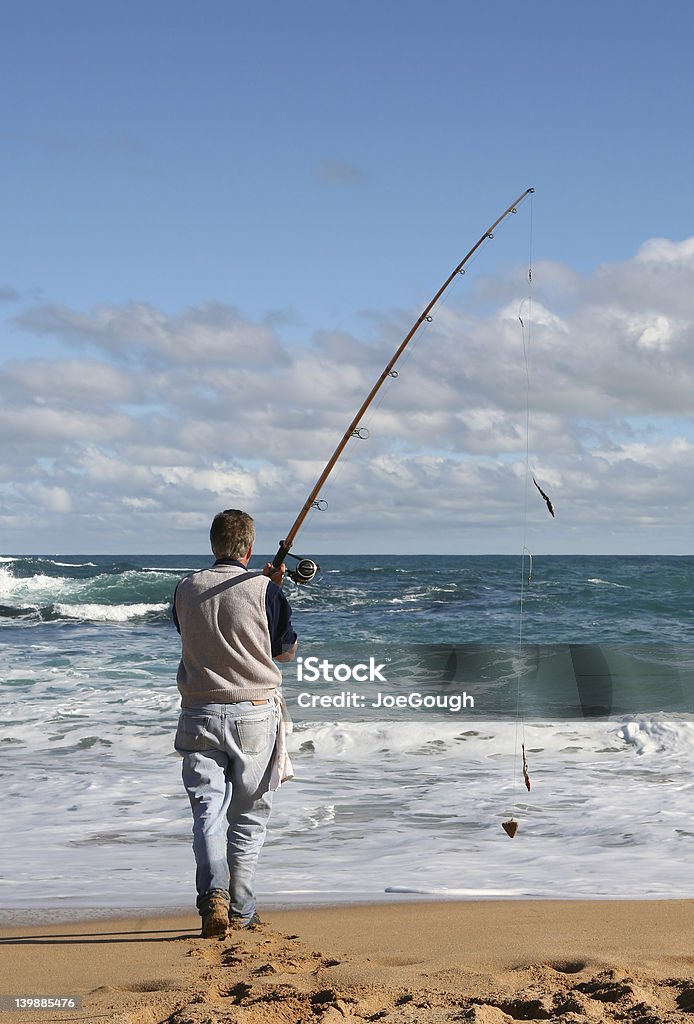 Gone Fishin' Retired guy enjoying leisure time on the beach Breaking Wave Stock Photo