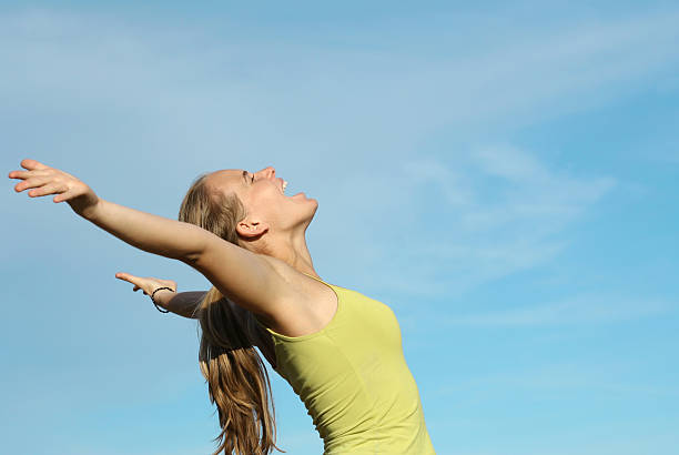 istock happy young woman arms raised with happiness and joy 139885708