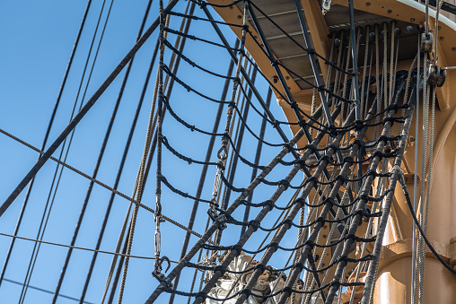 Close-up view of cordage hanging on a commercial fishing trawler on a sunny day.