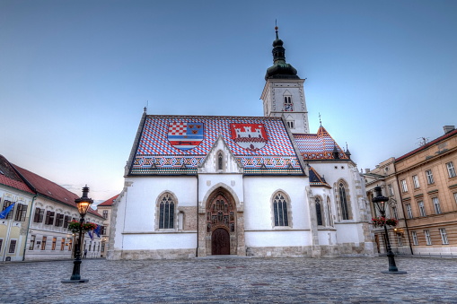 St Mark's Square with St Mark's Church in Zagreb, Croatia at sunset.