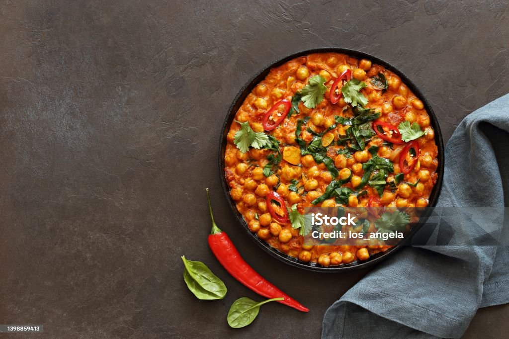 Spicy Chickpea and Spinach Curry. African chickpea stew. Spicy Chickpea and Spinach Curry. African chickpea stew. Flat layot Moroccan Culture Stock Photo