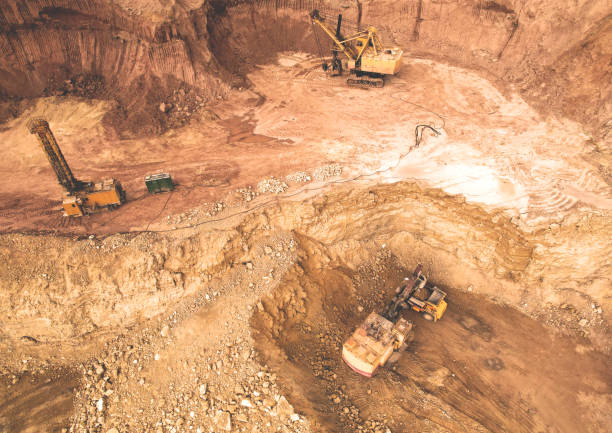 istock Excavator in open pit on dolomite development. Mining clay in quarry. Opencast for the extraction limestone. 1398859513