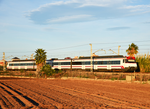 Train on railway. Speed train in motion on Valencia railroad. European passenger train on railway. High-speed train. Spanish National Rail Network.